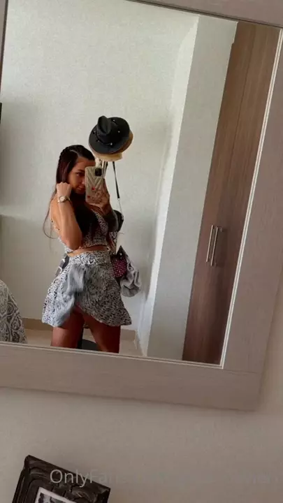 Yess Olivieri, full of attitude, lifting the skirt in front of the mirror